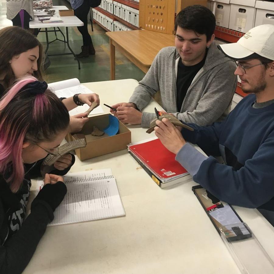 two female and two male undergraduate students in a material culture class
